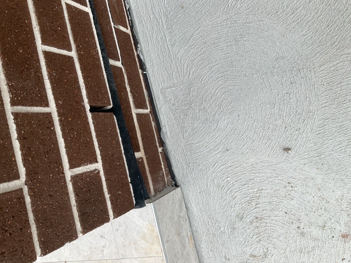 Cut back damp course, recorded during a handover inspection in Austral
